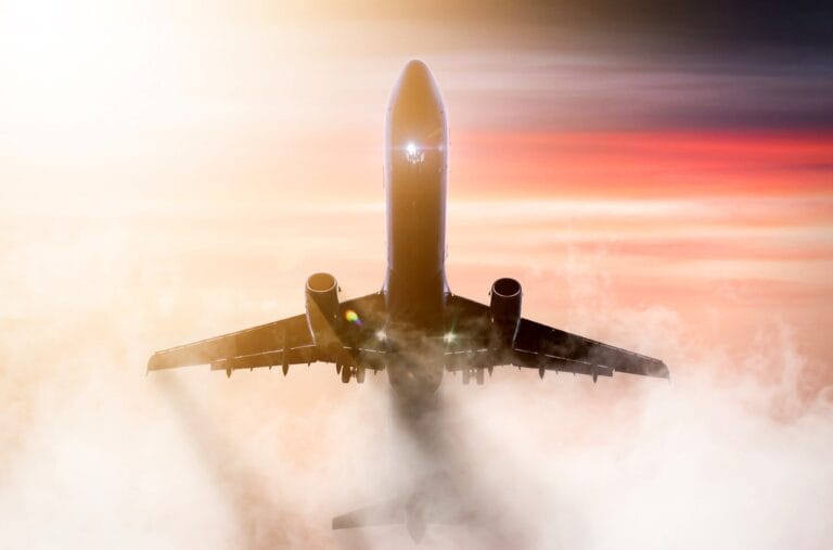 Plane flying through fog in twilight